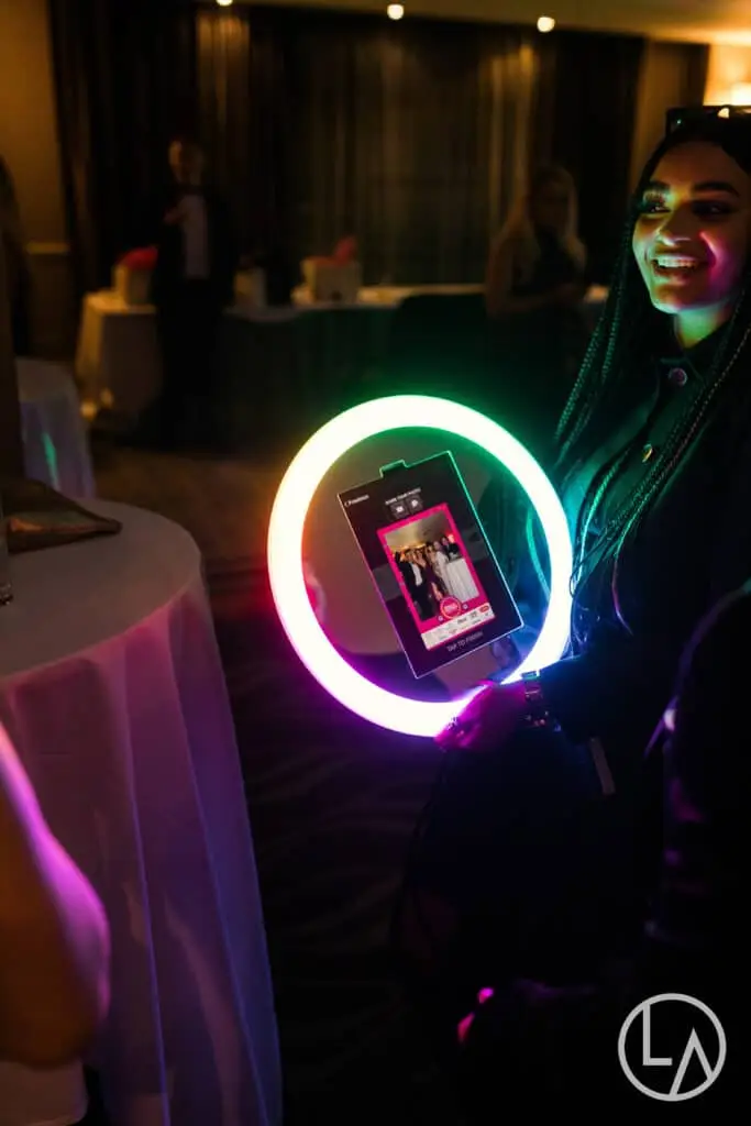 Guests reviewing their branded photo on the roaming photo booth screen in Kansas City