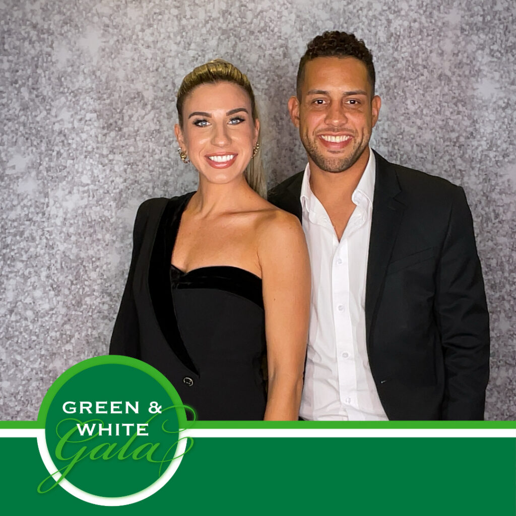A couple in black formalwear smile together against a silver sequin backdrop in a branded square print from the Green and White Gala, a nonprofit fundraiser photo experience by Lumen Activations.