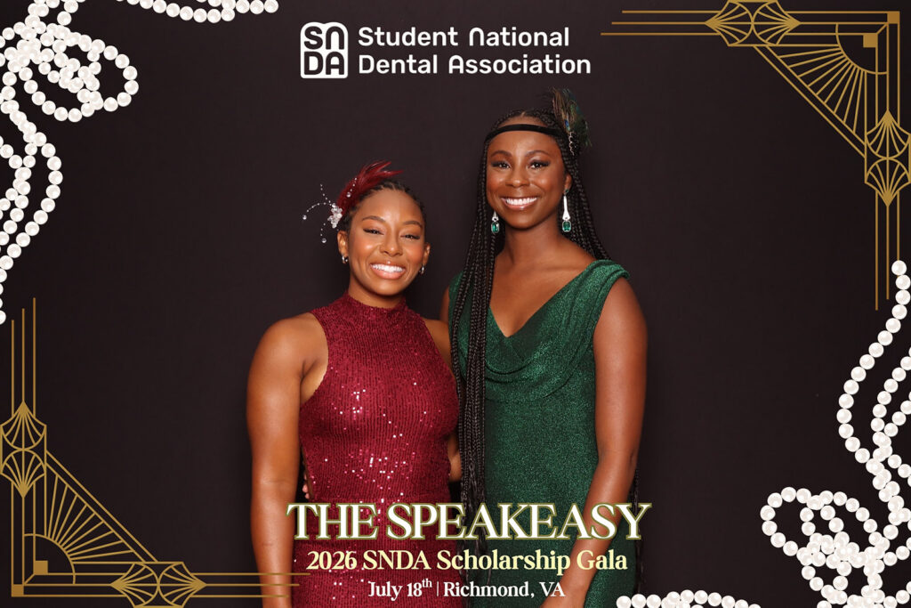 Attendees in jewel-toned attire pose at the Student National Dental Association's Speakeasy Scholarship Gala in Richmond, VA, a branded activation experience by Lumen Activations.
