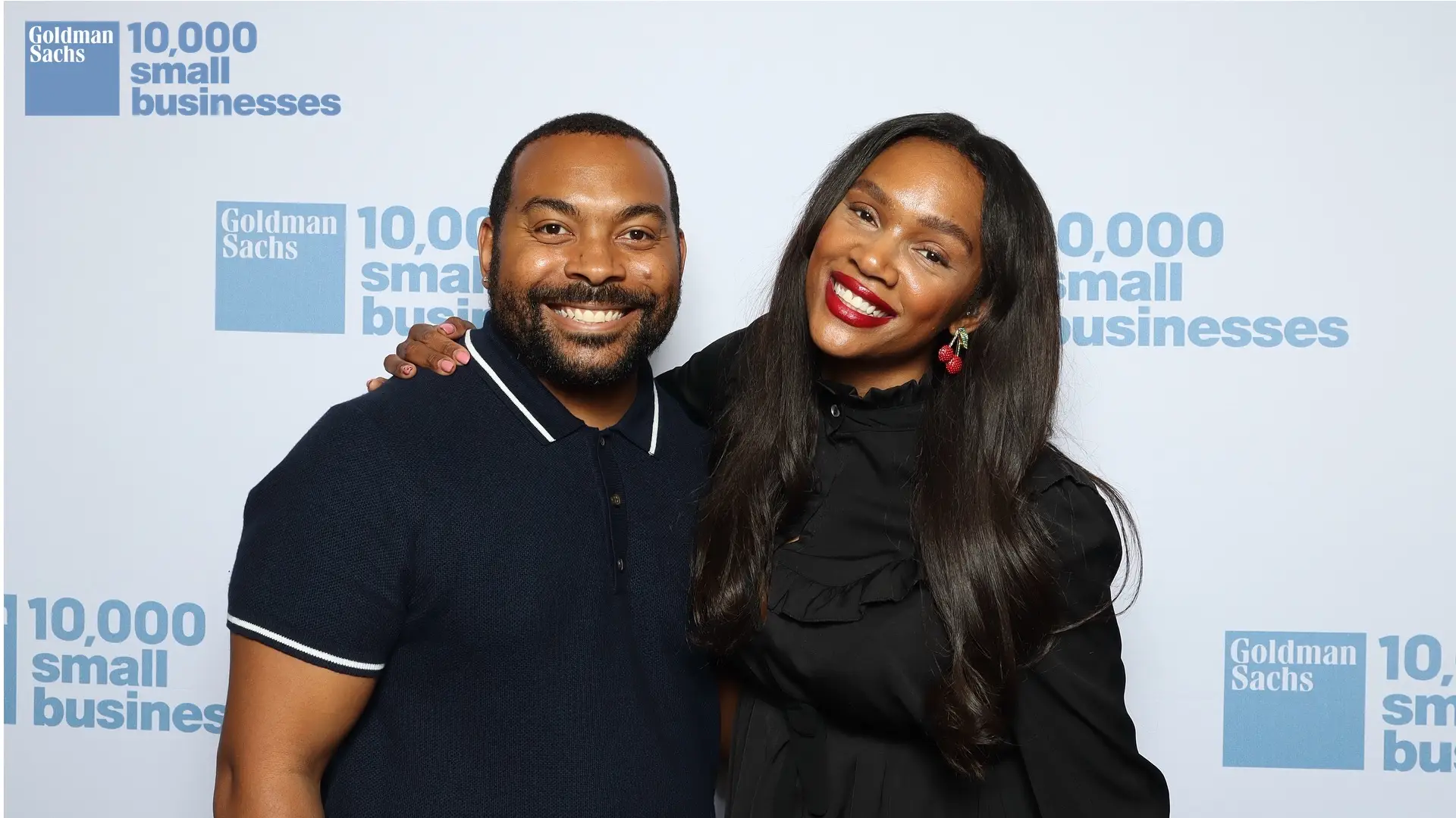 Two guests smiling at a Goldman Sachs 10,000 Small Businesses event before their AI-generated astronaut transformation