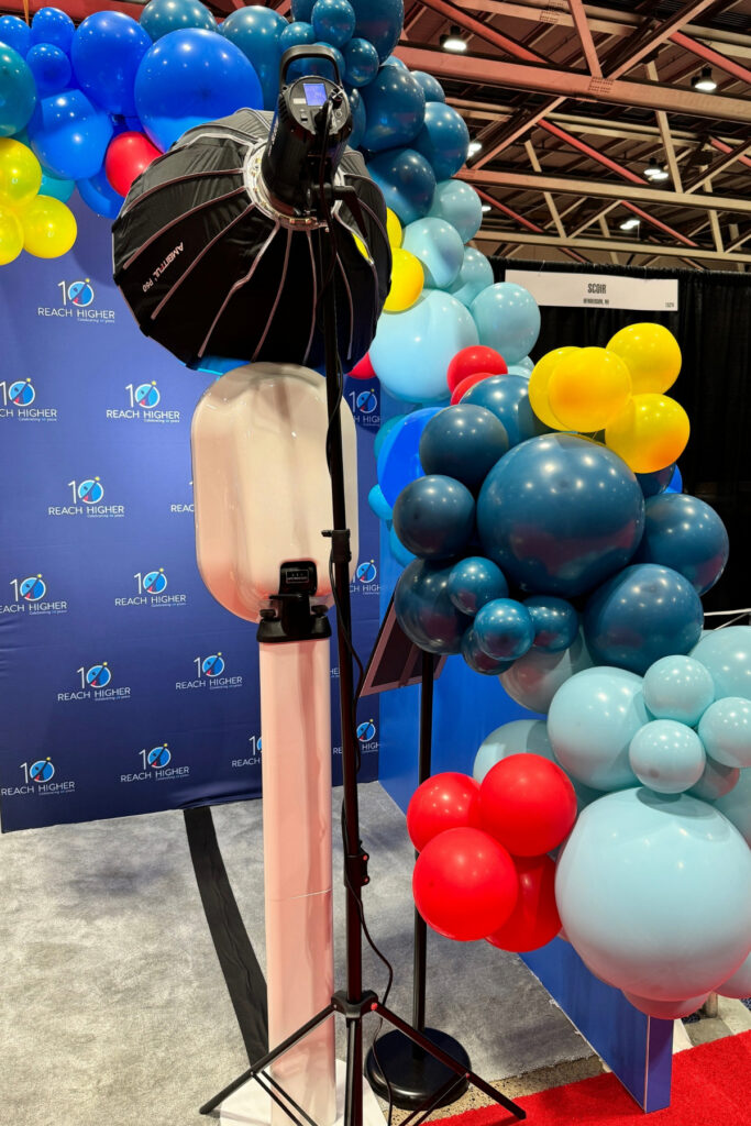 Lumen Activations photo experience with custom balloon garland installation at a corporate trade show booth